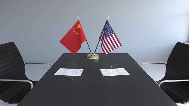 Flags of China and the United States of America and papers on the table. Negotiations and signing an international agreement. Conceptual 3D animation