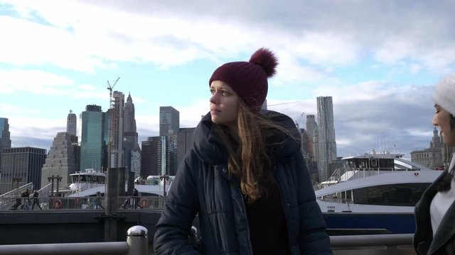 Two friends travel to New York for sightseeing at Brooklyn Bridge