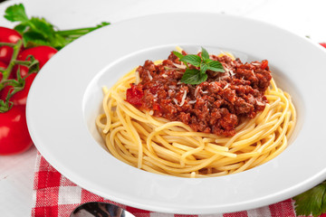 Pasta with meat, tomato sauce and vegetables on the table
