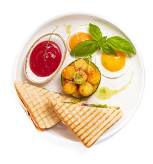 Sandwich with ham, cheese, tomatoes, lettuce, and toasted bread. Top view isolated on white background.