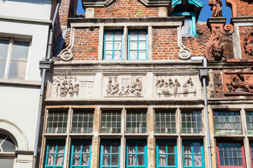 Facade of the Old house with images of christian virtues, Ghent, Belgium. 