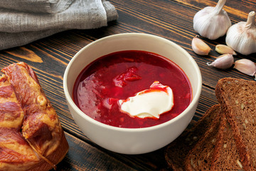 Borscht lard, rye bread and garlic on a wooden table.