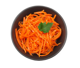 Korean pickled carrots salad in black bowl isolated on white background. top view