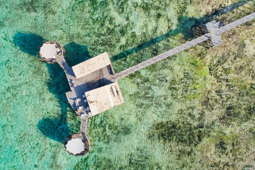 wooden bridge and restaurant above lagoon on Zanzibar