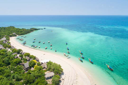 Fototapeta curved coast and beautiful beach with boats on Zanzibar island