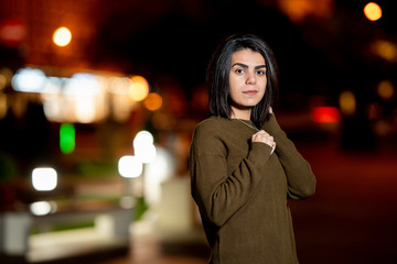 Young beautiful woman in evening night city