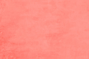 Living coral color painted cement wall. Color of the year 2019. Old stucco flat surface. Beautiful abstract grunge texture background with copy space