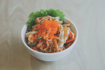 Salad crab stick mix with fresh vegetable and shrimp egg in glasses bowl