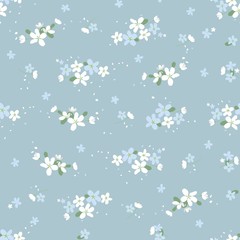 Seamless floral pattern with small cute flowers on a  light blue background. light floral texture.