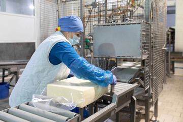 Worker packs butter at the dairy plant