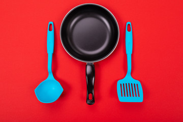 Kitchen utensils for cooking in kitchen isolated with copyspace on red background