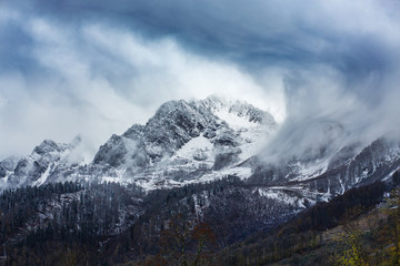 Fototapeta na wymiar View of beautiful mountain shrouded in blue clouds