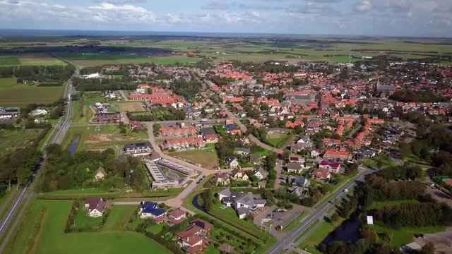 Aerial view of the city of Den Burg on the island of Texel - drone in flight over a quaint Dutch town revealing its wonderful neighborhoods, houses and farmlands around the town. Travel concept - Nort