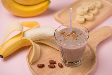 Fresh made Banana smoothie on pink background
