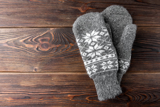 Warm Mittens On Wooden Background.