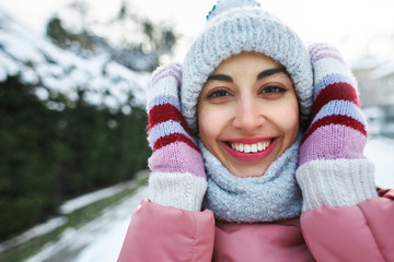 happy joyful smiling woman happily walking outdoors at frosty snowy winter day