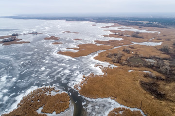 Frozen ice on the shore of the sea as a background, a bird's-eye view. Early winter