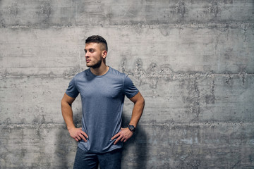 Sporty Caucasian man standing in front of the wall in sportswear. Your body is a reflection of your...