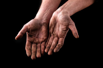 Dirty hands isolated on black background. Begging hands.