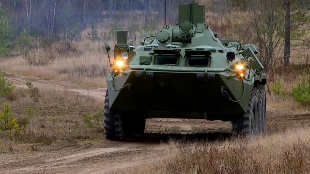 Military exercises in the open area with the use of armored vehicles, tanks and assault forces.