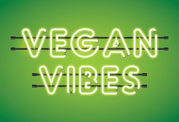 Vegan Vibes neon florescent lighting message on a green background