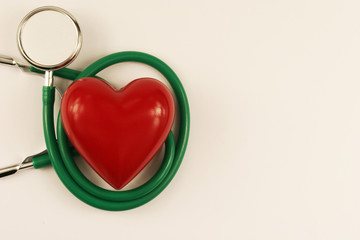 Stethoscope and heart on white background.