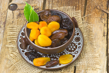 dried fruits in a bowl on wooden background