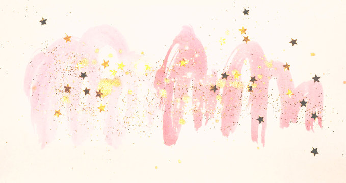 Golden glitter and glittering stars on abstract pink watercolor splashes in vintage nostalgic colors.