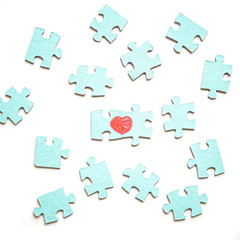Two pieces of a puzzle forming a heart, depicting the idea that love is a matter of two, on a white background. Blue puzzle on white background.