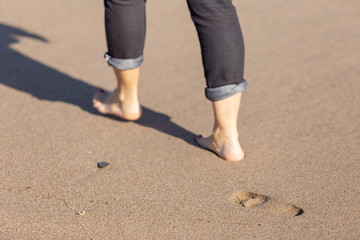 footprint of a woman walking barefoot on the sand