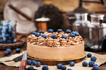 Delicious homemade chocolate cheesecake decorated with fresh blueberries