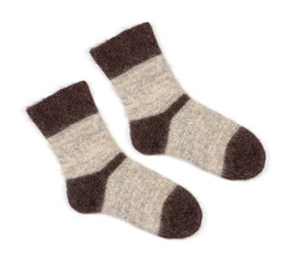 male grey knitted socks of dog fur on white background close up, top view