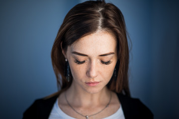 Cute girl with red hair shyly closes her eyes, long eyelashes. portrait of a modern woman, face in freckles