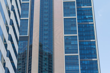 Fototapeta premium Building facade with modern window design for steel glass office tower. Copy space and fade.
