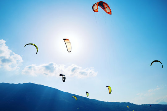 Colorful paragliding formation above Santa Croce Lake