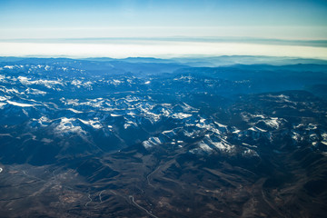 Fototapeta na wymiar California mountains covered with Snow aerial View from airplane, California, USA