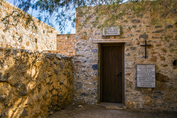 Entrance to the historic chapel at the cemetery on the leper island. Historic buildings in the Spinalonga fortress, Crete.