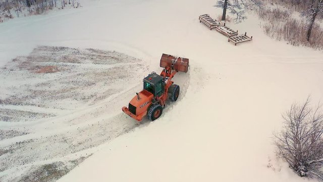 Piling up snow with a front end loader