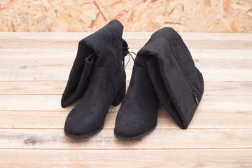 Lady's footwear, Leather high boots over wood background