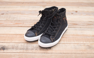 Sneaker style Canvas shoes at wood background