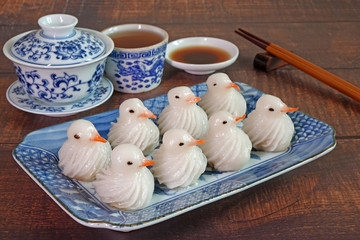 Dumplings : Bird-shaped dumplings (White pigeon), beautiful Chinese dumpling on blue and white porcelain dish.
