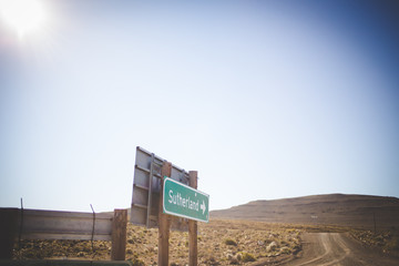 Wide angle view of roadsigns on a dirtroad, in the karoo region of south africa, showing the direction to the towns of Sutherland and Laingsburg