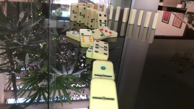 Domino Effect on a reflecting piano surface