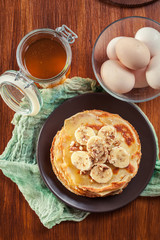 Thin pancakes with banana, walnuts and honey