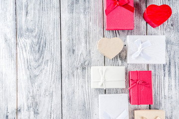 Valentine day concept, old grey wooden background with gift boxes, top view copy space