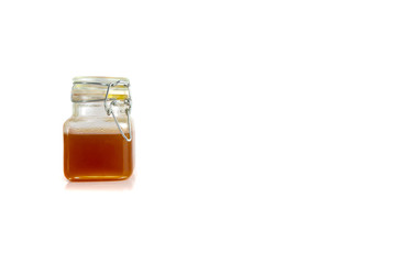 Honey in jar isolated on white background with selective focus