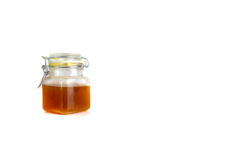 Honey in jar isolated on white background with selective focus