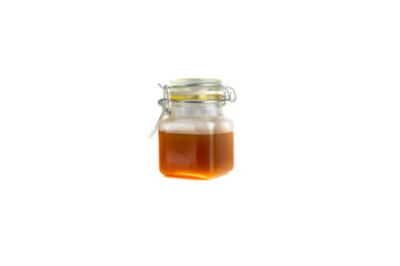 Honey in jar isolated on white background with selective focus