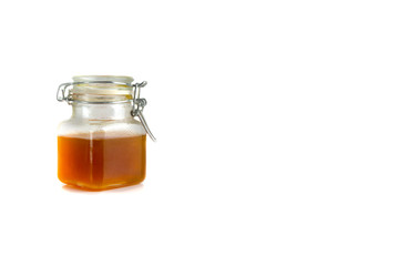Honey in jar isolated on white background with selective focus