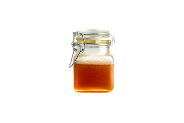 Honey in jar isolated on white background with selective focus